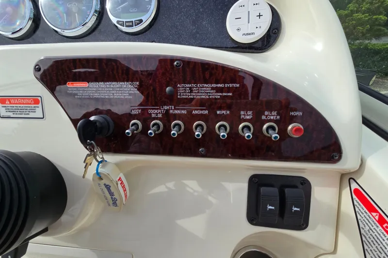 Slide: The Image of Control panel of a 2006 Sea Ray 240 Sundancer boat with switches and gauges. - 28