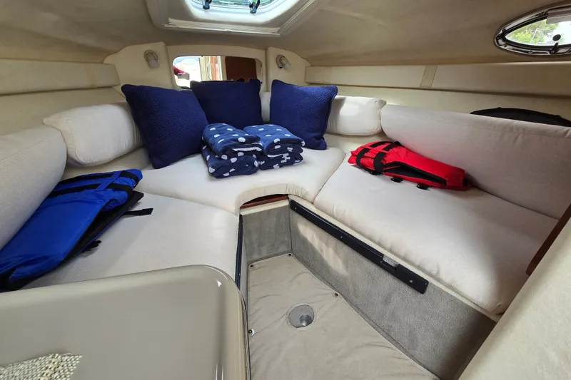 Slide: The Image of 2006 Sea Ray 240 Sundancer cabin interior with cushions and life jackets. - 44