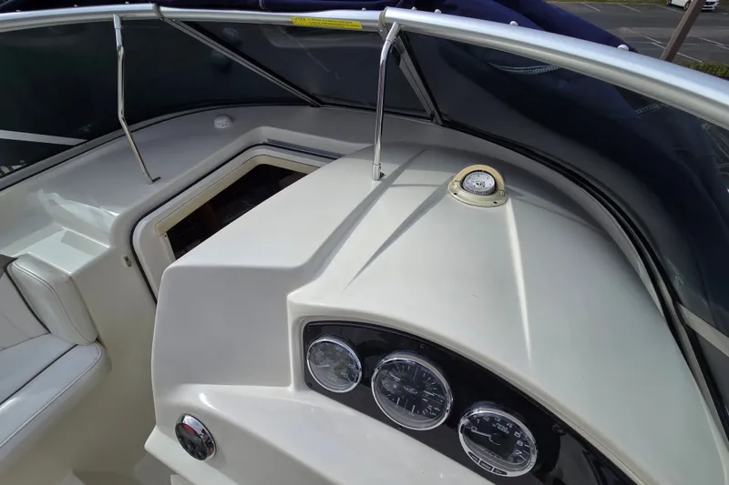 Slide: The Image of 2006 Sea Ray 240 Sundancer dashboard with gauges and compass. - 30