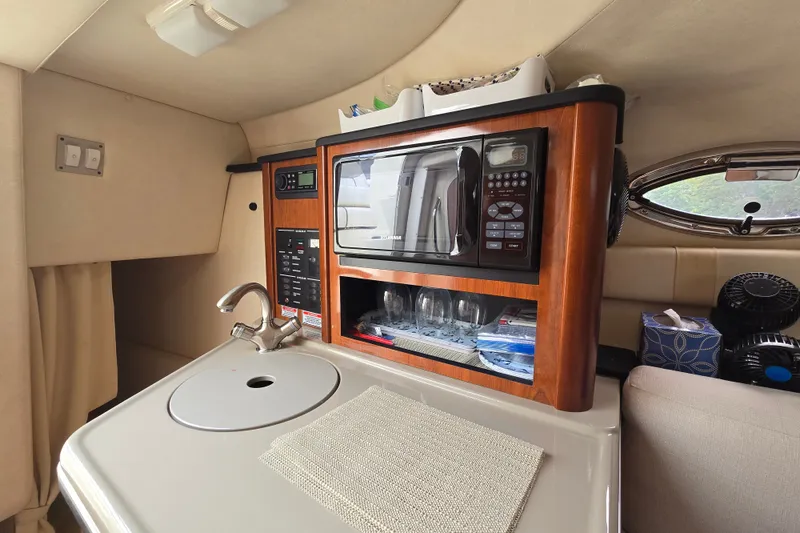 Slide: The Image of Interior of 2006 Sea Ray 240 Sundancer with kitchenette, microwave, and sink. - 46
