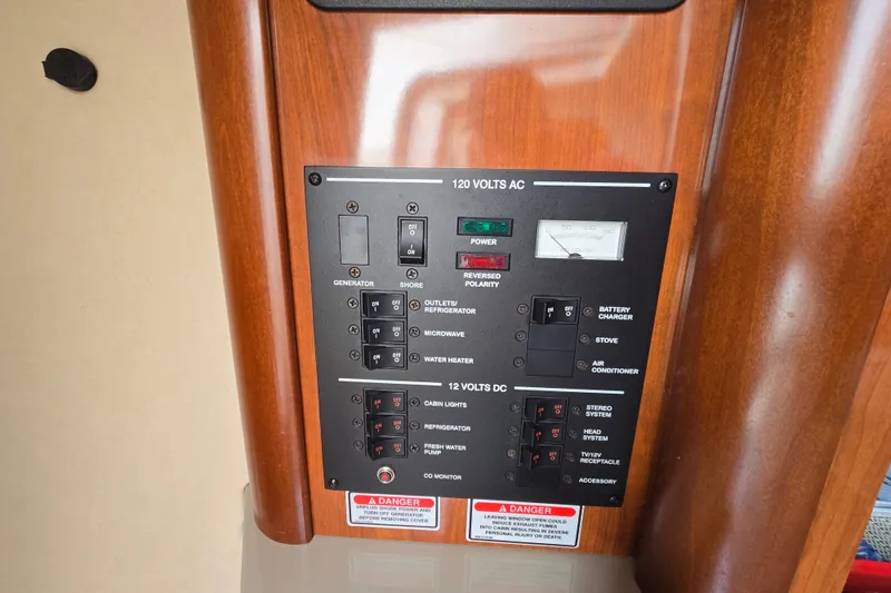 Slide: The Image of Electrical control panel on a 2006 Sea Ray 240 Sundancer boat. - 52