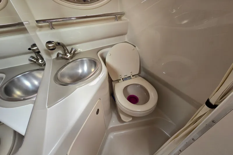 Slide: The Image of 2006 Sea Ray 240 Sundancer bathroom with sink and toilet. - 47