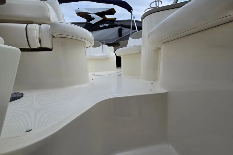 Slide: The Image of 2006 Sea Ray 240 Sundancer boat interior with white seating and clean deck. - 24