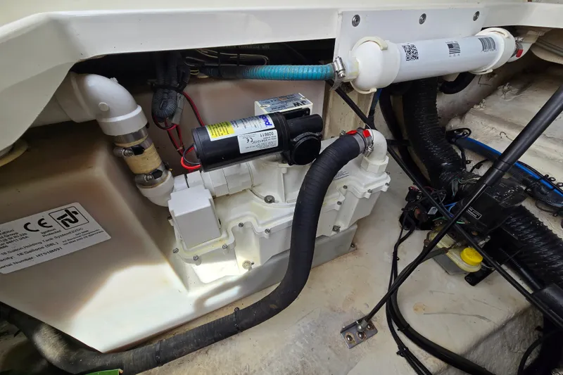 Slide: The Image of Engine compartment of a 2006 Sea Ray 240 Sundancer boat, showcasing mechanical components. - 36