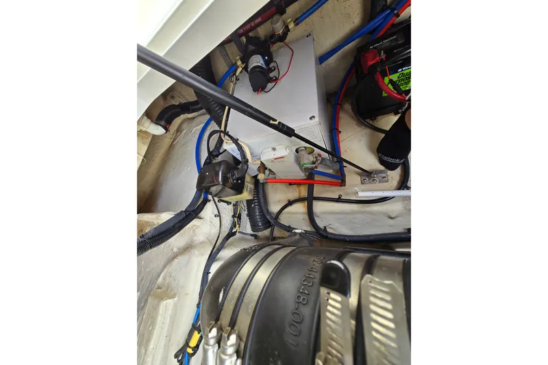 Slide: The Image of Engine compartment of a 2006 Sea Ray 240 Sundancer with visible wiring and components. - 34