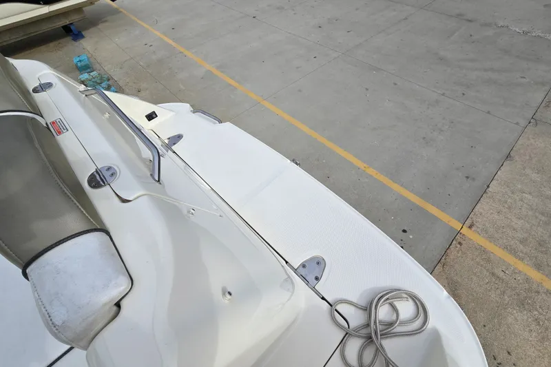 Slide: The Image of 2006 Sea Ray 240 Sundancer boat docked, showing deck and seating area. - 22
