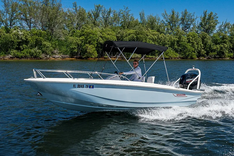 Slide: The Image of 2022 Boston Whaler 160 Super Sport cruising on a scenic waterway. - 29