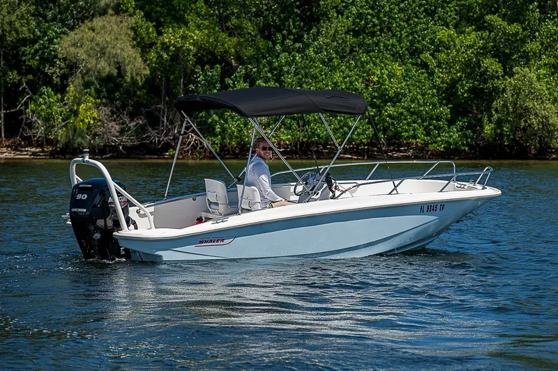 Slide: The Image of 2022 Boston Whaler 160 Super Sport boat cruising on a scenic waterway. - 18
