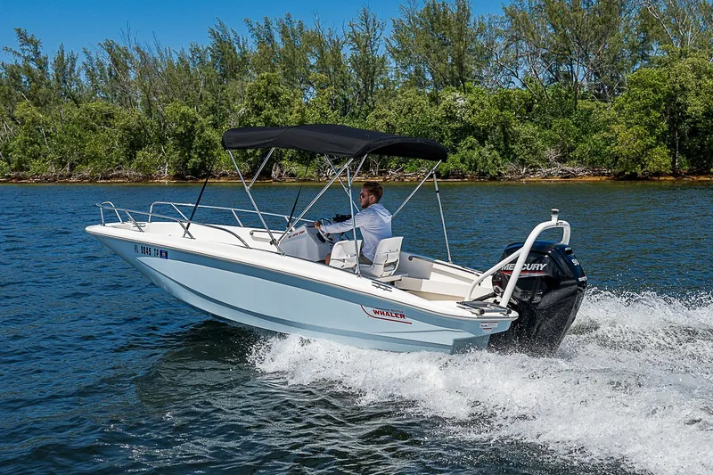 Slide: The Image of 2022 Boston Whaler 160 Super Sport cruising on a scenic lake. - 28