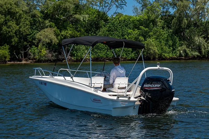 Slide: The Image of 2022 Boston Whaler 160 Super Sport boat cruising on a scenic waterway. - 13