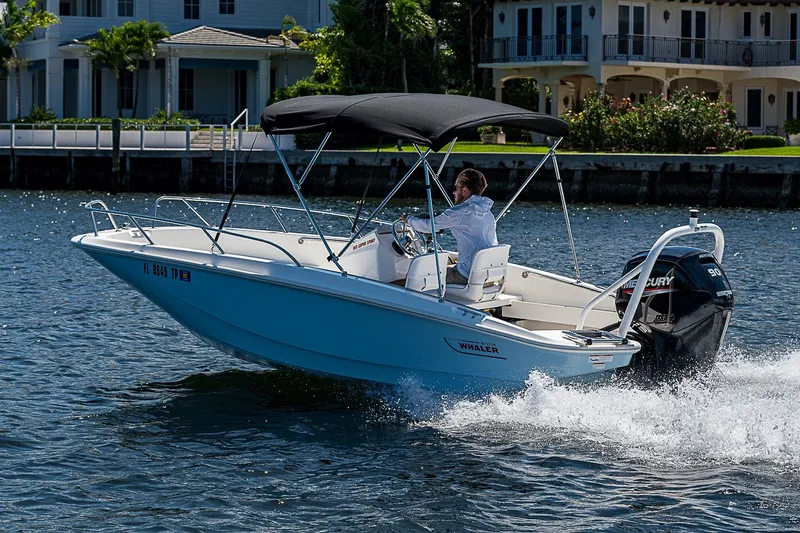 Slide: The Image of 2022 Boston Whaler 160 Super Sport cruising on water near waterfront homes. - 35