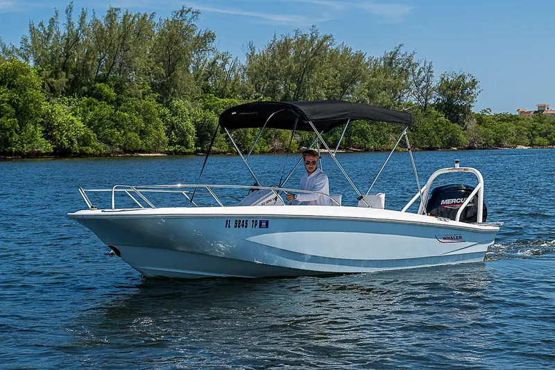 Slide: The Image of 2022 Boston Whaler 160 Super Sport boat cruising on a scenic waterway. - 10