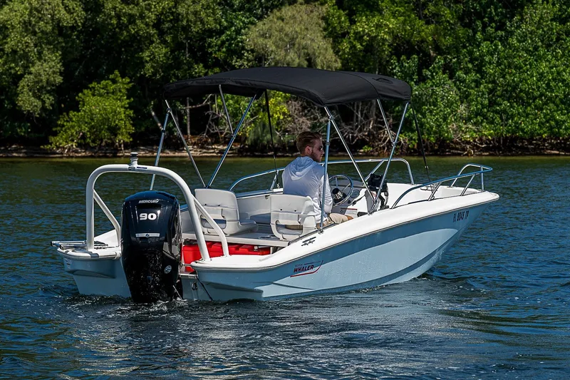 Slide: The Image of 2022 Boston Whaler 160 Super Sport boat cruising on a scenic waterway. - 17