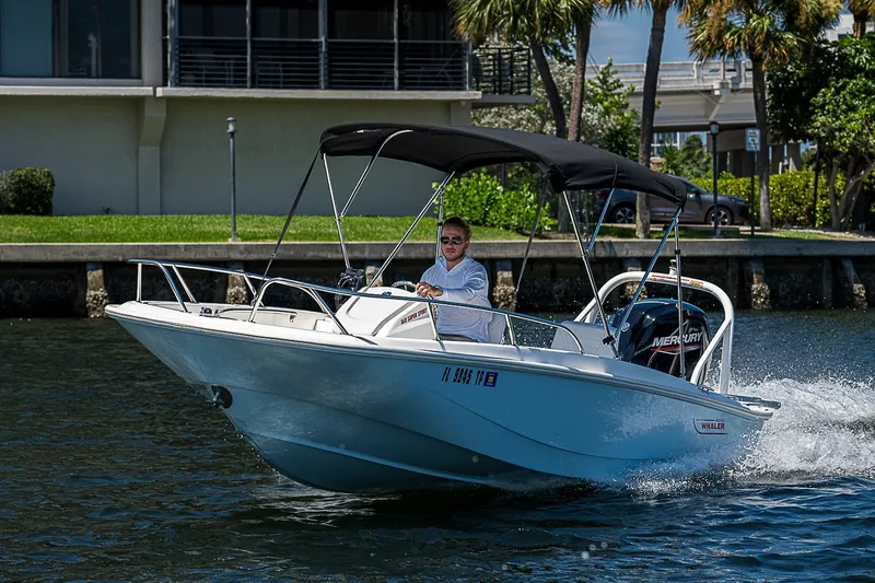 Slide: The Image of 2022 Boston Whaler 160 Super Sport boat cruising on a sunny day. - 33