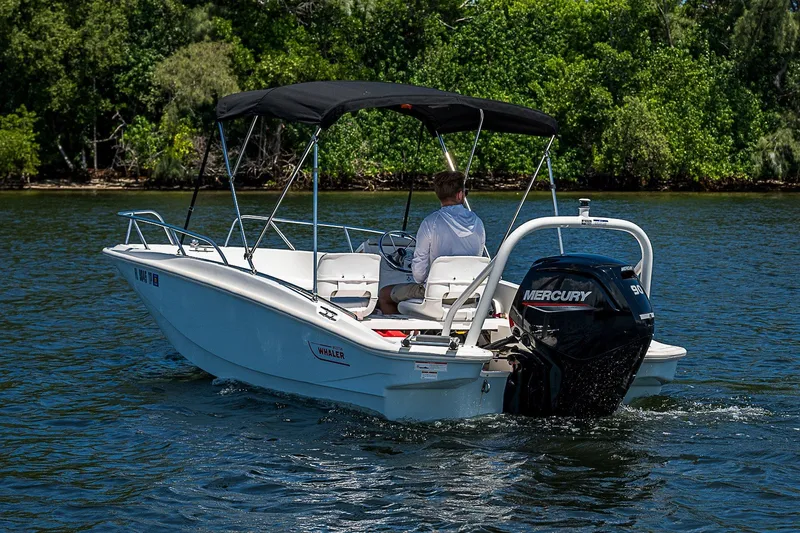 Slide: The Image of 2022 Boston Whaler 160 Super Sport boat cruising on a scenic waterway. - 14