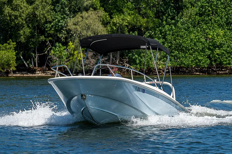 Slide: The Image of 2022 Boston Whaler 160 Super Sport cruising on a scenic waterway. - 39