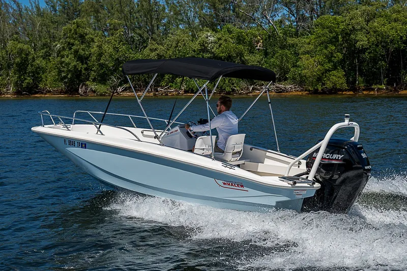 Slide: The Image of 2022 Boston Whaler 160 Super Sport boat cruising on a scenic waterway. - 26