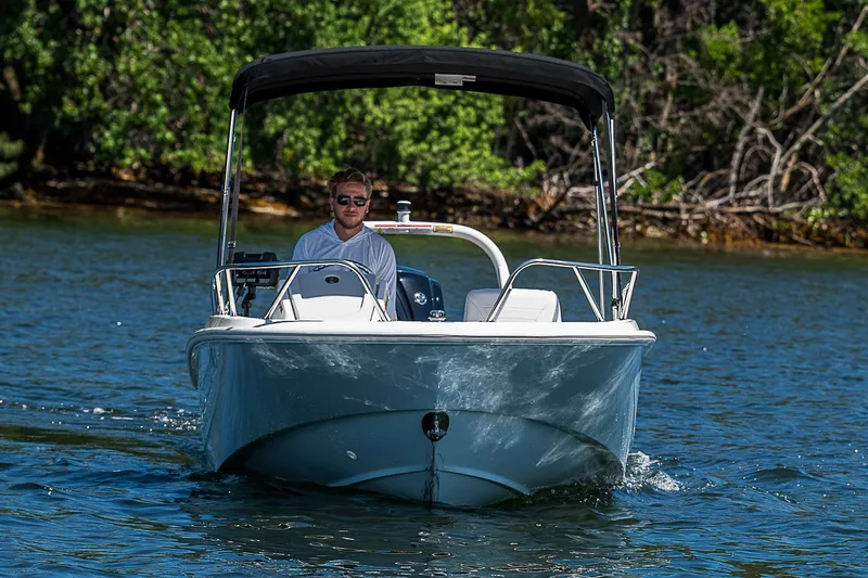 Slide: The Image of 2022 Boston Whaler 160 Super Sport boat cruising on a sunny day. - 23