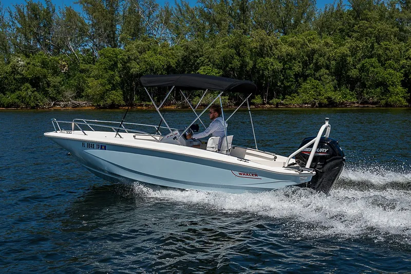 Slide: The Image of 2022 Boston Whaler 160 Super Sport cruising on a scenic waterway. - 25