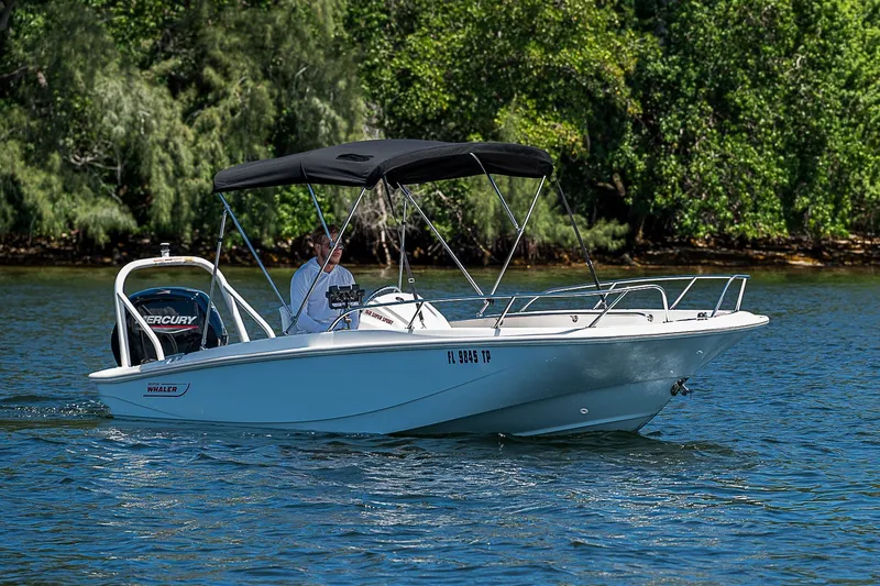 Slide: The Image of 2022 Boston Whaler 160 Super Sport boat cruising on a scenic waterway. - 21