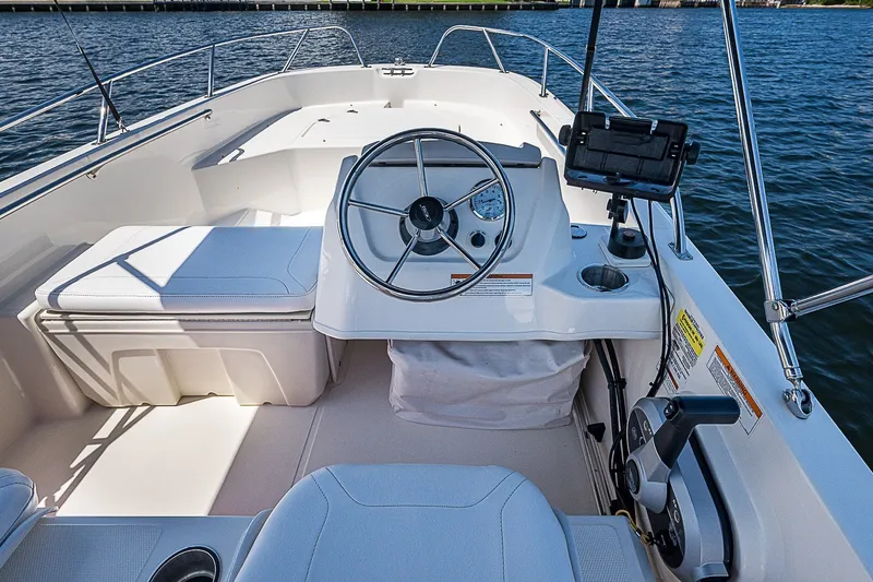 Slide: The Image of 2022 Boston Whaler 160 Super Sport boat interior with steering wheel and controls. - 7