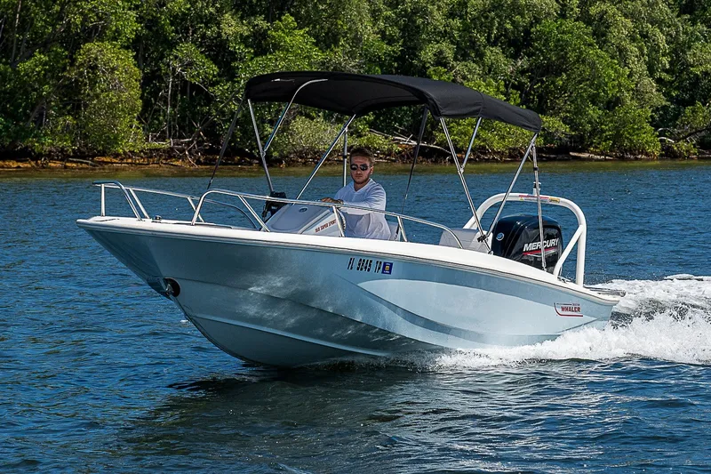 Slide: The Image of 2022 Boston Whaler 160 Super Sport cruising on a scenic waterway. - 31