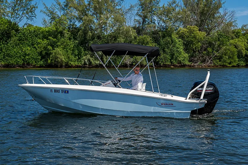 Slide: The Image of 2022 Boston Whaler 160 Super Sport boat cruising on a scenic waterway. - 12