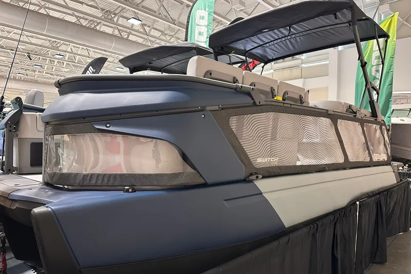 The Image of 2025 Sea-Doo Switch Cruise Limited 21 pontoon boat displayed indoors. - 0
