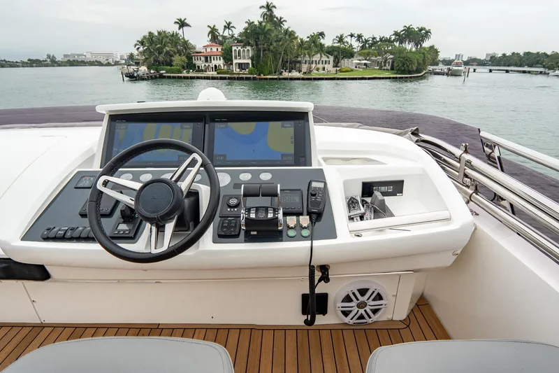 Slide: The Image of Helm of 2017 Princess S65 yacht with navigation controls, overlooking scenic waterfront. - 40