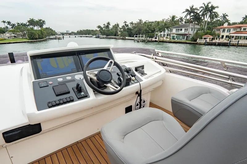 Slide: The Image of 2017 Princess S65 yacht helm with modern controls, overlooking a scenic waterfront. - 39