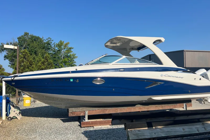 Slide: The Image of 2022 Crownline Eclipse E305 XS boat on display outdoors. - 4