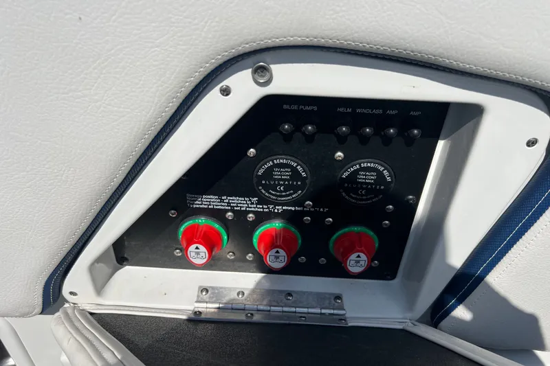 Slide: The Image of Control panel of a 2022 Crownline Eclipse E305 XS boat with switches and relays. - 38