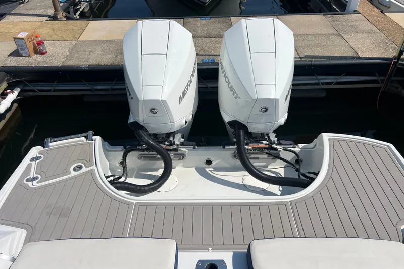 Slide: The Image of 2022 Crownline Eclipse E305 XS boat with dual Mercury outboard engines at dock. - 39