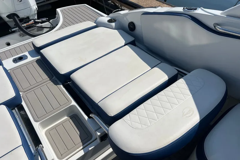Slide: The Image of 2022 Crownline Eclipse E305 XS boat interior with cushioned seating and deck. - 20