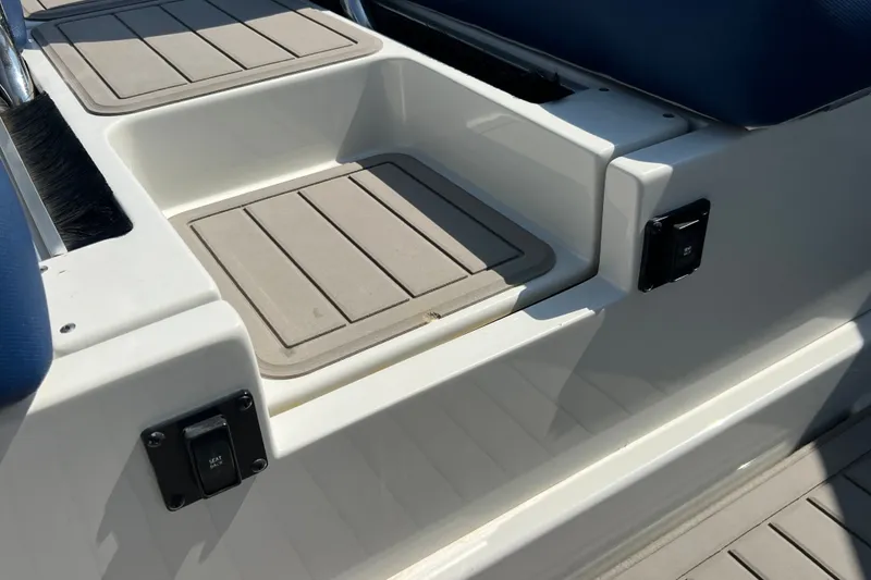 Slide: The Image of 2022 Crownline Eclipse E305 XS boat seating area with storage compartments. - 41
