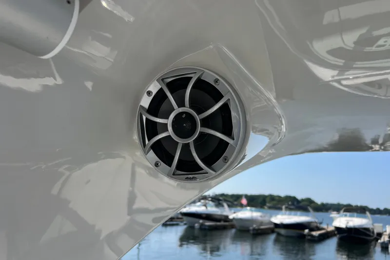 Slide: The Image of 2022 Crownline Eclipse E305 XS boat speaker with marina background. - 34