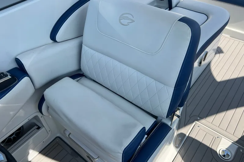 Slide: The Image of Luxury seating on 2022 Crownline Eclipse E305 XS boat, featuring white and blue upholstery. - 29