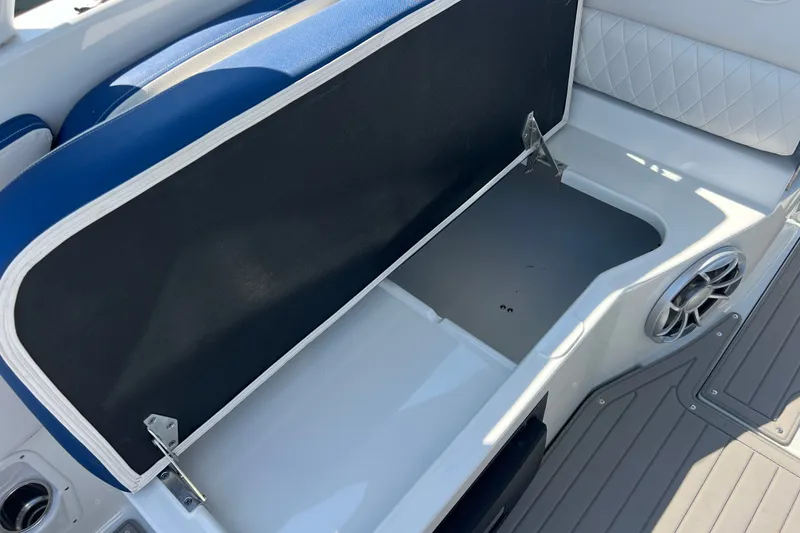 Slide: The Image of 2022 Crownline Eclipse E305 XS boat interior storage compartment with blue and white seating. - 36