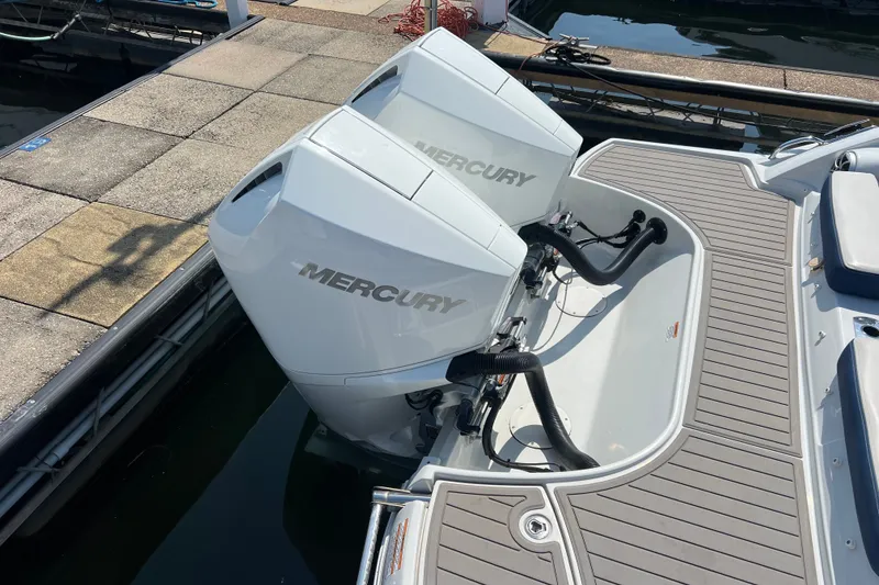 Slide: The Image of 2022 Crownline Eclipse E305 XS with dual Mercury outboard engines at dock. - 15