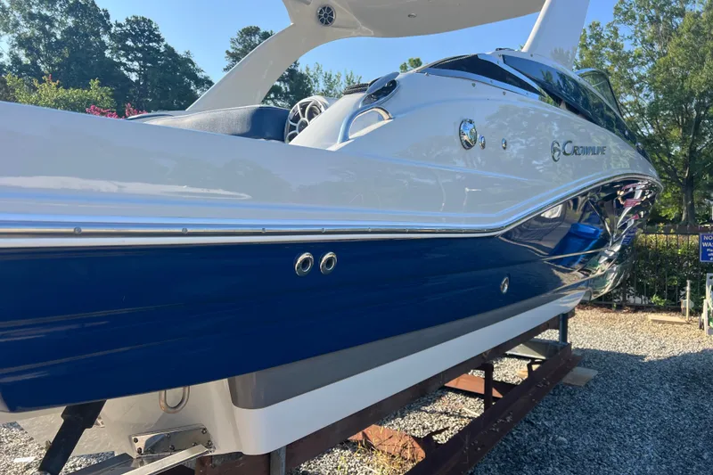 Slide: The Image of 2022 Crownline Eclipse E305 XS boat with sleek blue and white design on display. - 9