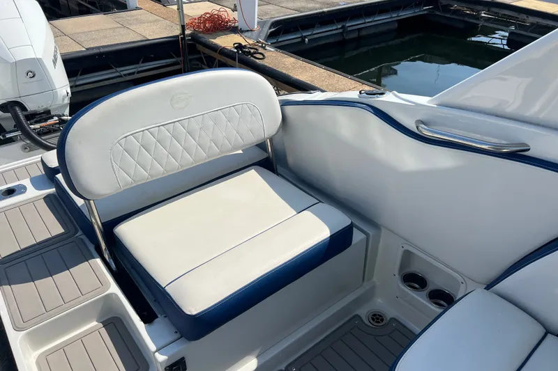 Slide: The Image of 2022 Crownline Eclipse E305 XS boat seating area with white and blue upholstery. - 19