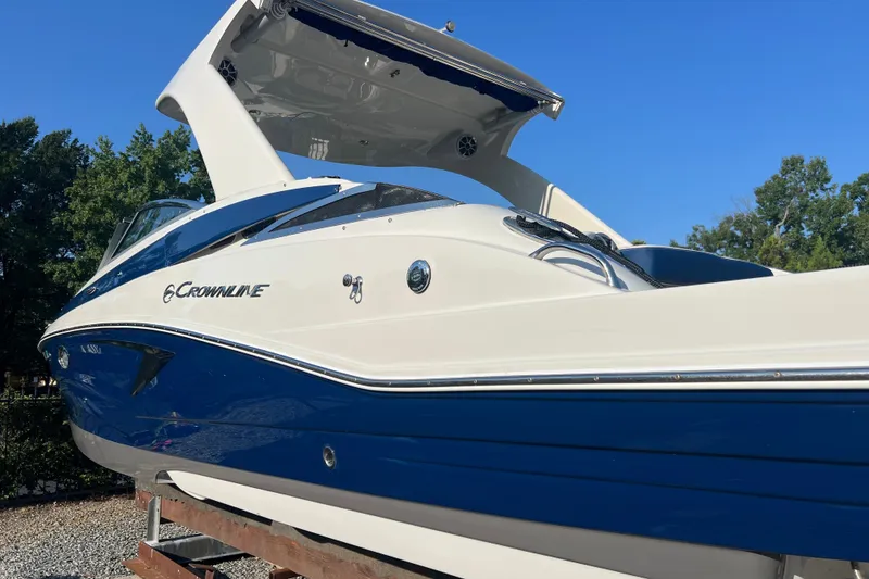 Slide: The Image of 2022 Crownline Eclipse E305 XS boat with sleek blue and white design. - 2