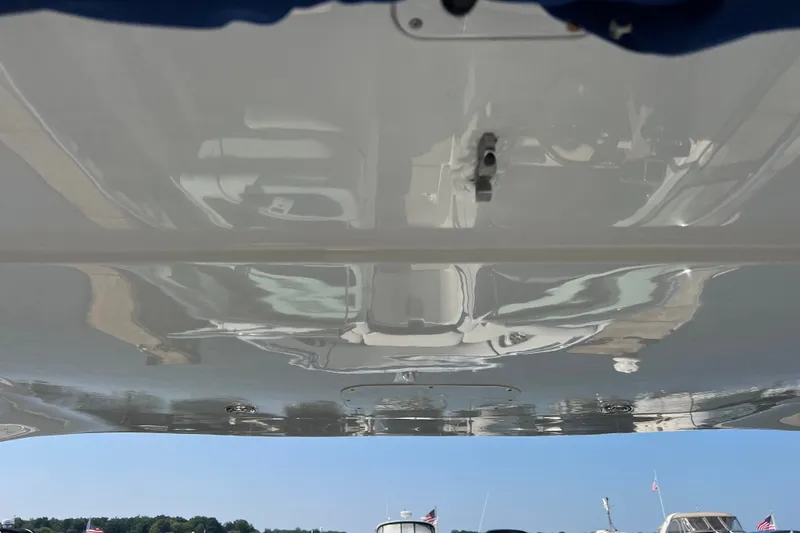 Slide: The Image of 2022 Crownline Eclipse E305 XS boat underside reflecting sky and nearby boats. - 42