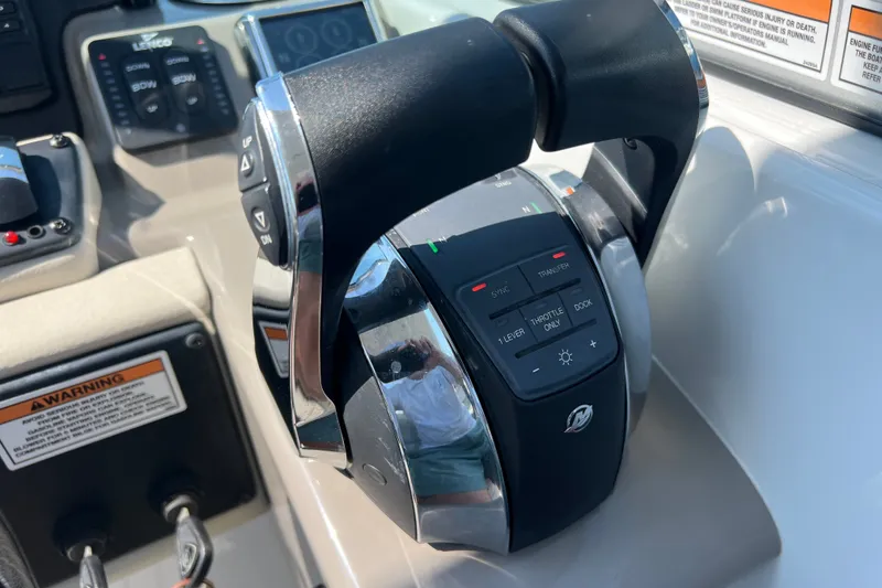 Slide: The Image of Throttle control panel on 2022 Crownline Eclipse E305 XS boat dashboard. - 25