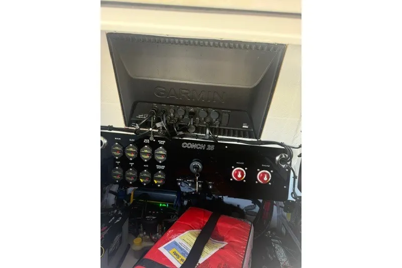 Slide: The Image of Control panel of a 2027 Conch 25 boat with Garmin display and gauges. - 12