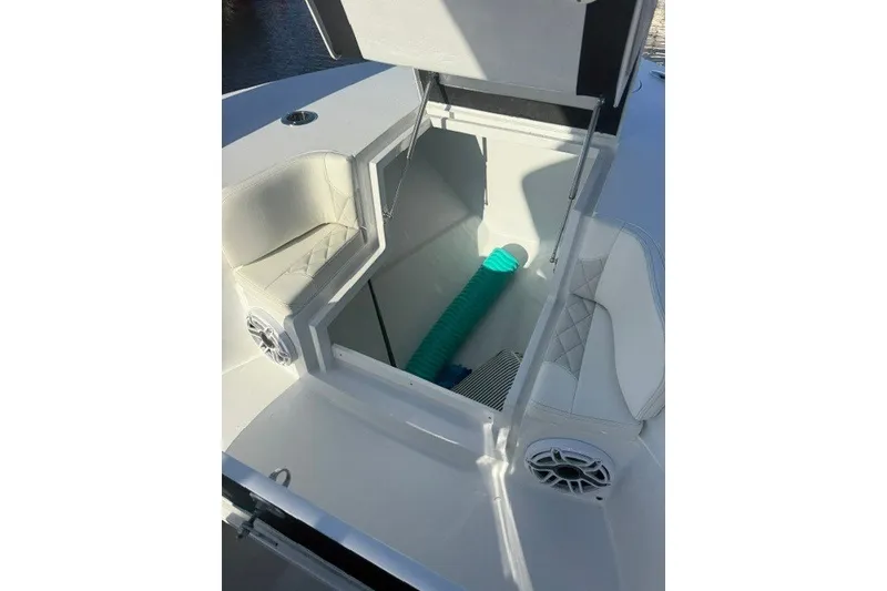 Slide: The Image of Open storage compartment on 2027 Conch 25 boat with seating and speaker. - 10