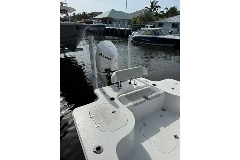 Slide: The Image of 2027 Conch 25 boat with outboard motor docked in marina. - 9
