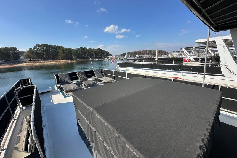 Slide: The Image of Rooftop deck of 2004 Lakeview 16x68 houseboat with lounge chairs on a sunny day. - 16