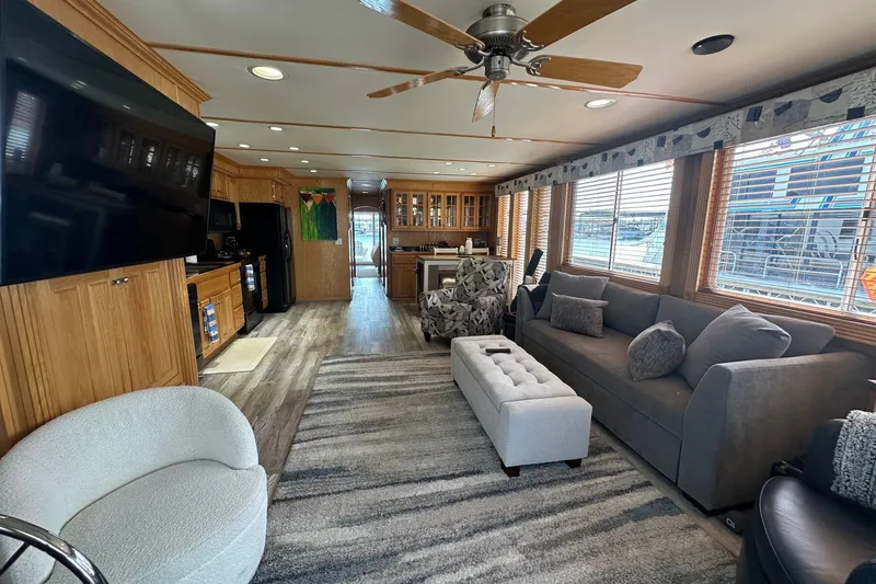 Slide: The Image of Spacious 2004 Lakeview 16x68 houseboat interior with modern furnishings and large windows. - 2