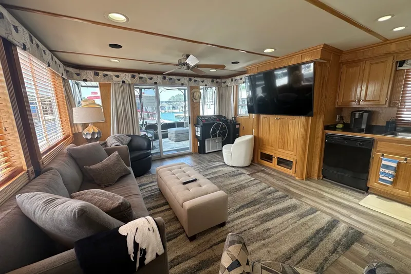 Slide: The Image of Luxurious 2004 Lakeview 16x68 houseboat interior with cozy seating, large TV, and modern kitchen. - 3